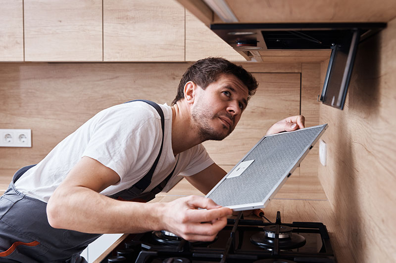 Technician assessing a refrigerator for a Castle Hill appliance repair